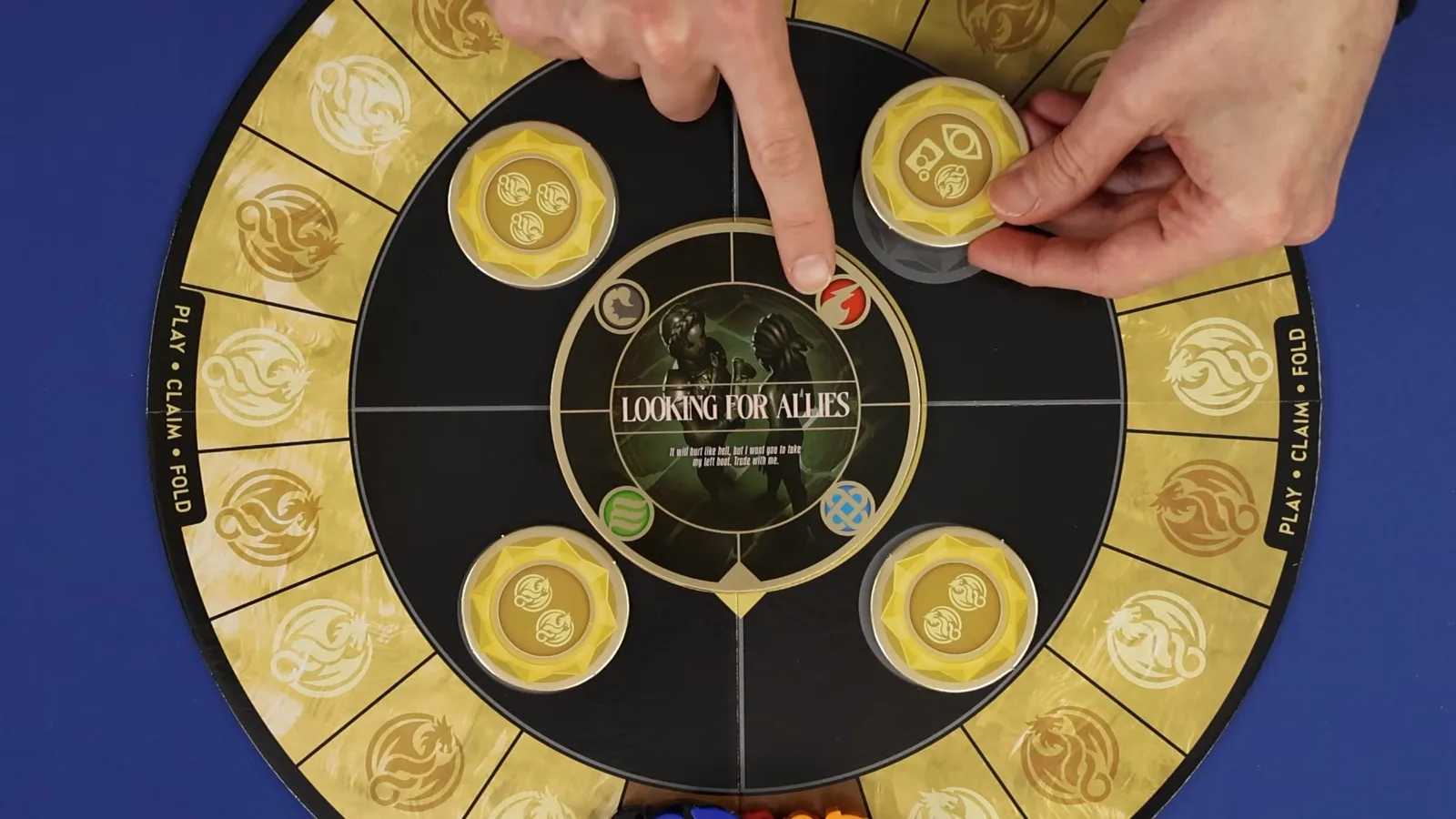 Un jugador señala una ficha dorada de reclamo en el tablero de Rise of the Wingleader, con la carta de evento LOOKING FOR ALLIES boca arriba en el centro.